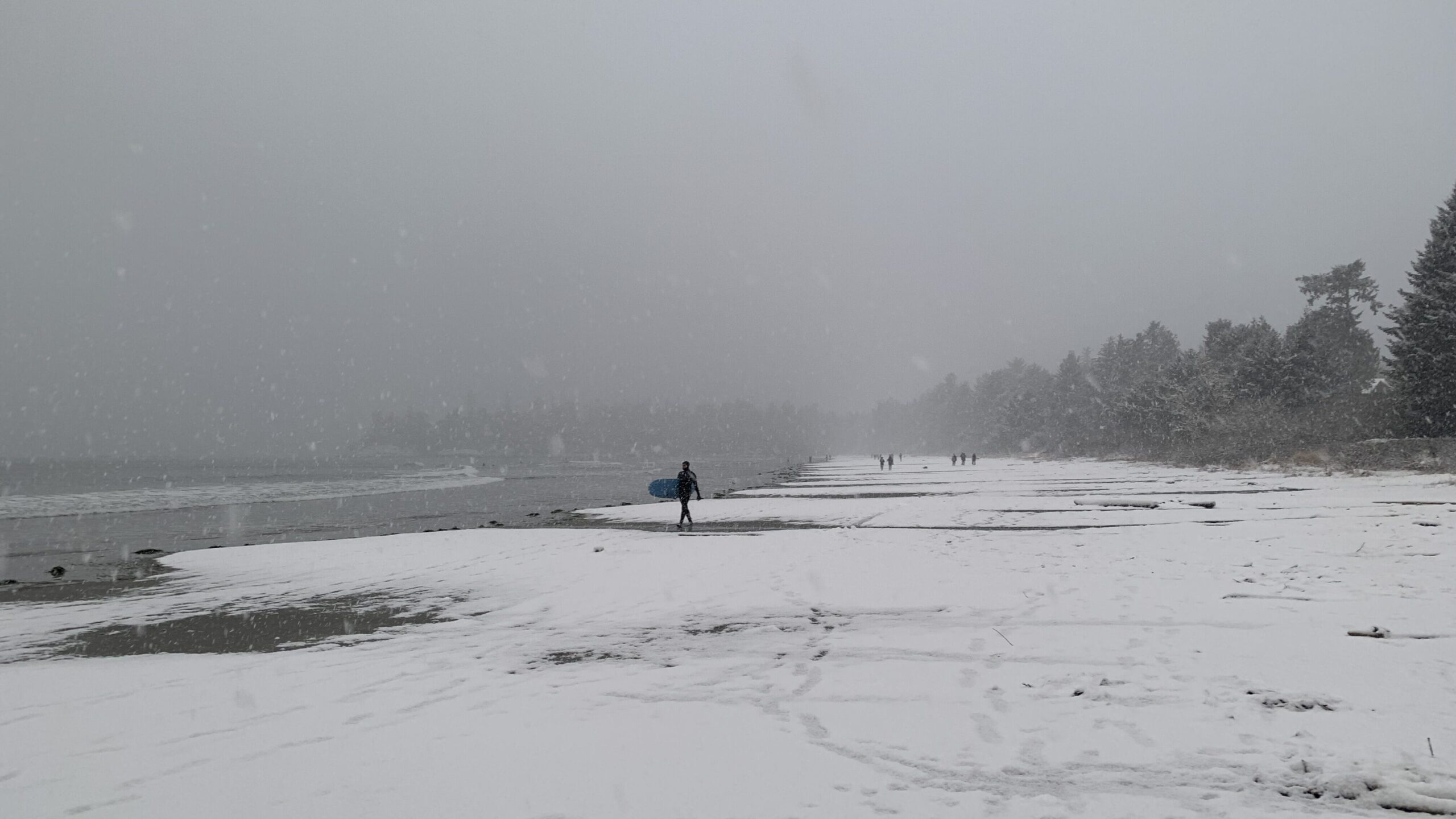 surfer walking in the snow
